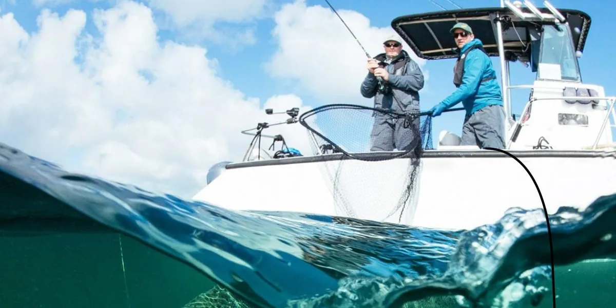 Two anglers working a line from a boat