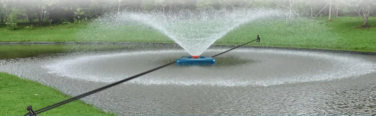 A floating fountain throwing a wide spray on a pond in daylight